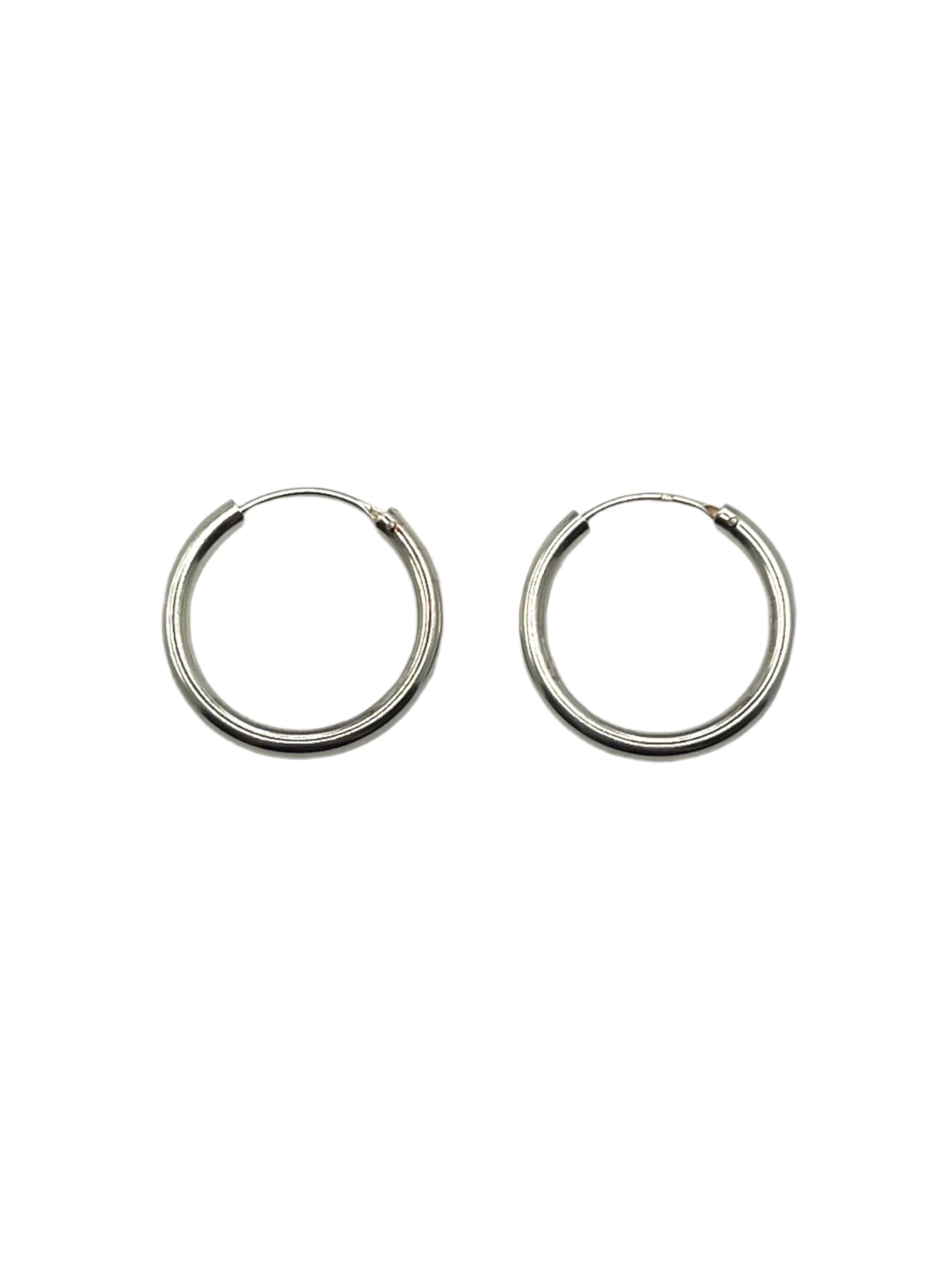 Pair of silver hoop earrings on a light gray background