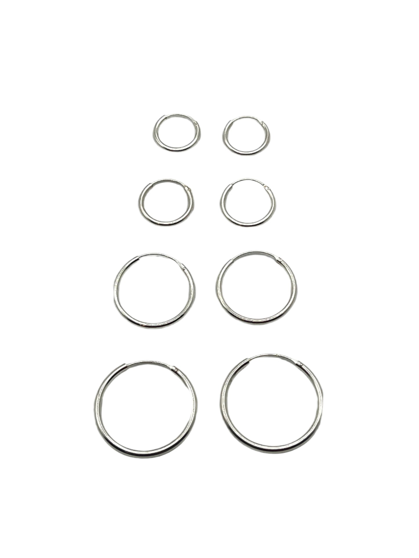 Set of silver hoop earrings on a light gray background