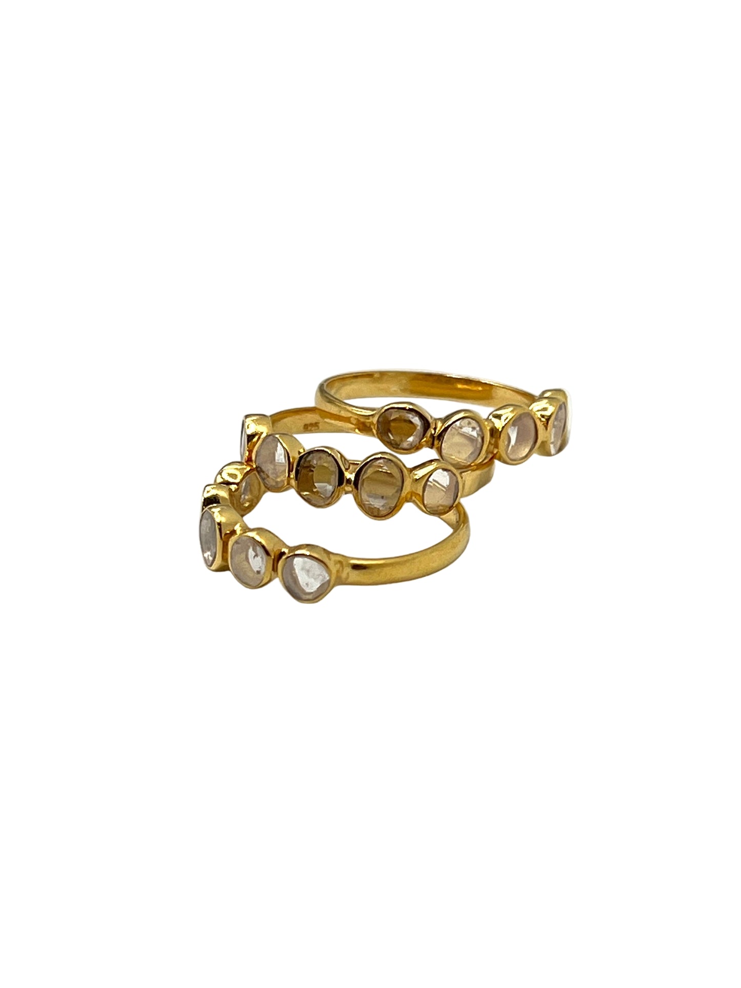Two gold rings with embedded stones on a white background
