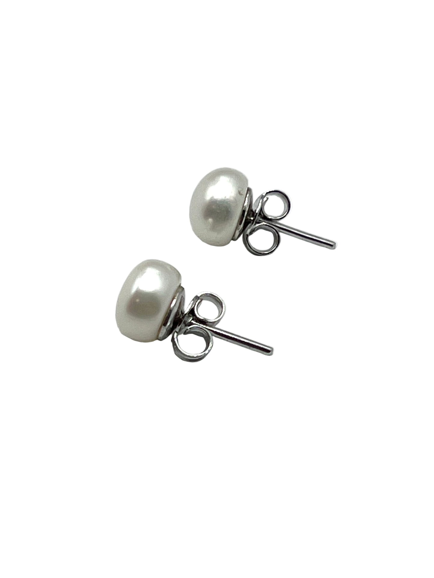 Pair of pearl stud earrings on a light gray background
