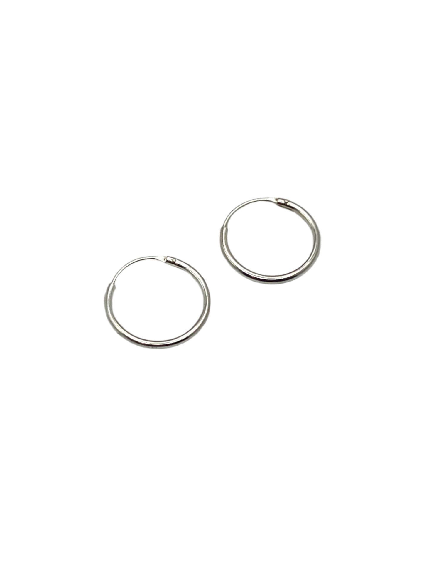 Pair of silver hoop earrings on a light gray background