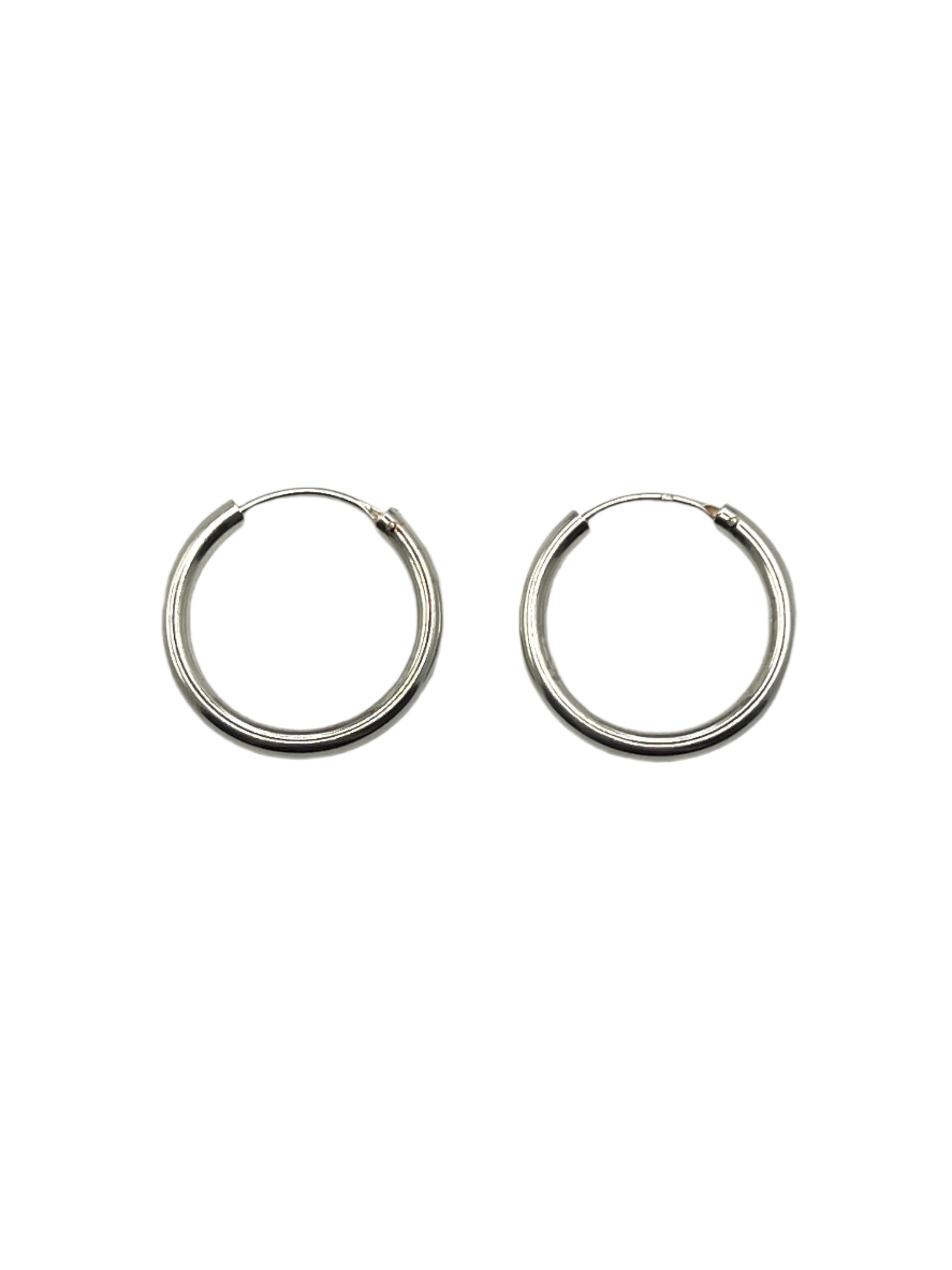 Pair of silver hoop earrings on a light gray background