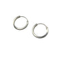 Pair of silver hoop earrings on a gray background