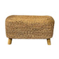 A rectangular hand made accent bench made of water hyacinth with teakwood legs.