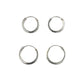 Four silver hoop earrings on a gray background