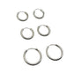 Set of six silver hoop earrings on a light gray background