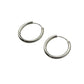 Pair of silver hoop earrings on a light gray background