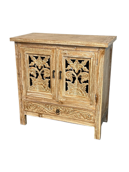 A white washed teak wood vanity with hand made lotus floral carvings on the doors and sides, with a cabinet and drawer compartment.