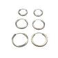 Set of six silver hoop earrings on a gray background