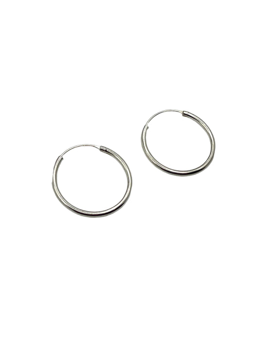 Pair of silver hoop earrings on a light gray background