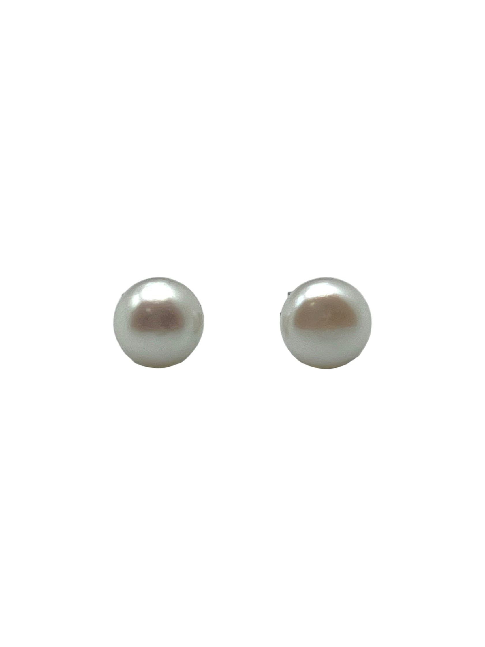Pair of pearl earrings on a light gray background