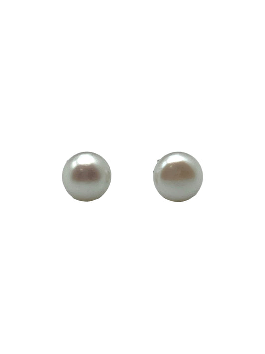 Pair of pearl earrings on a light gray background
