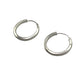 Pair of silver hoop earrings on a gray background