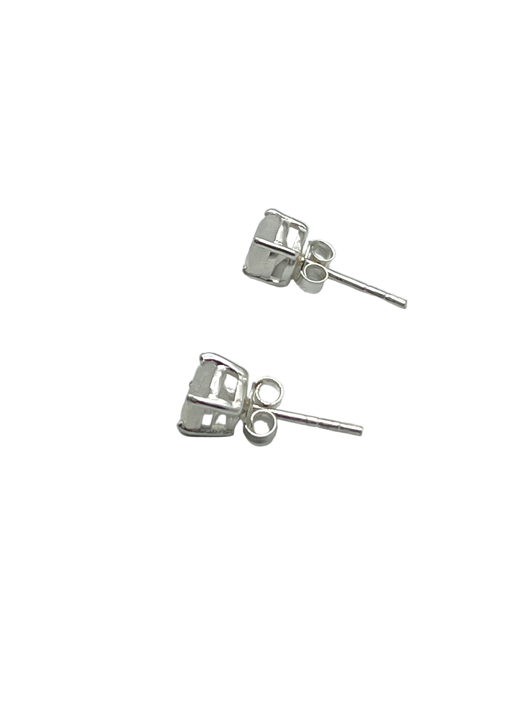 Silver stud earrings on a light gray background