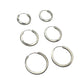 Set of silver hoop earrings on a gray background