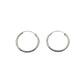 Two silver hoop earrings on a light gray background