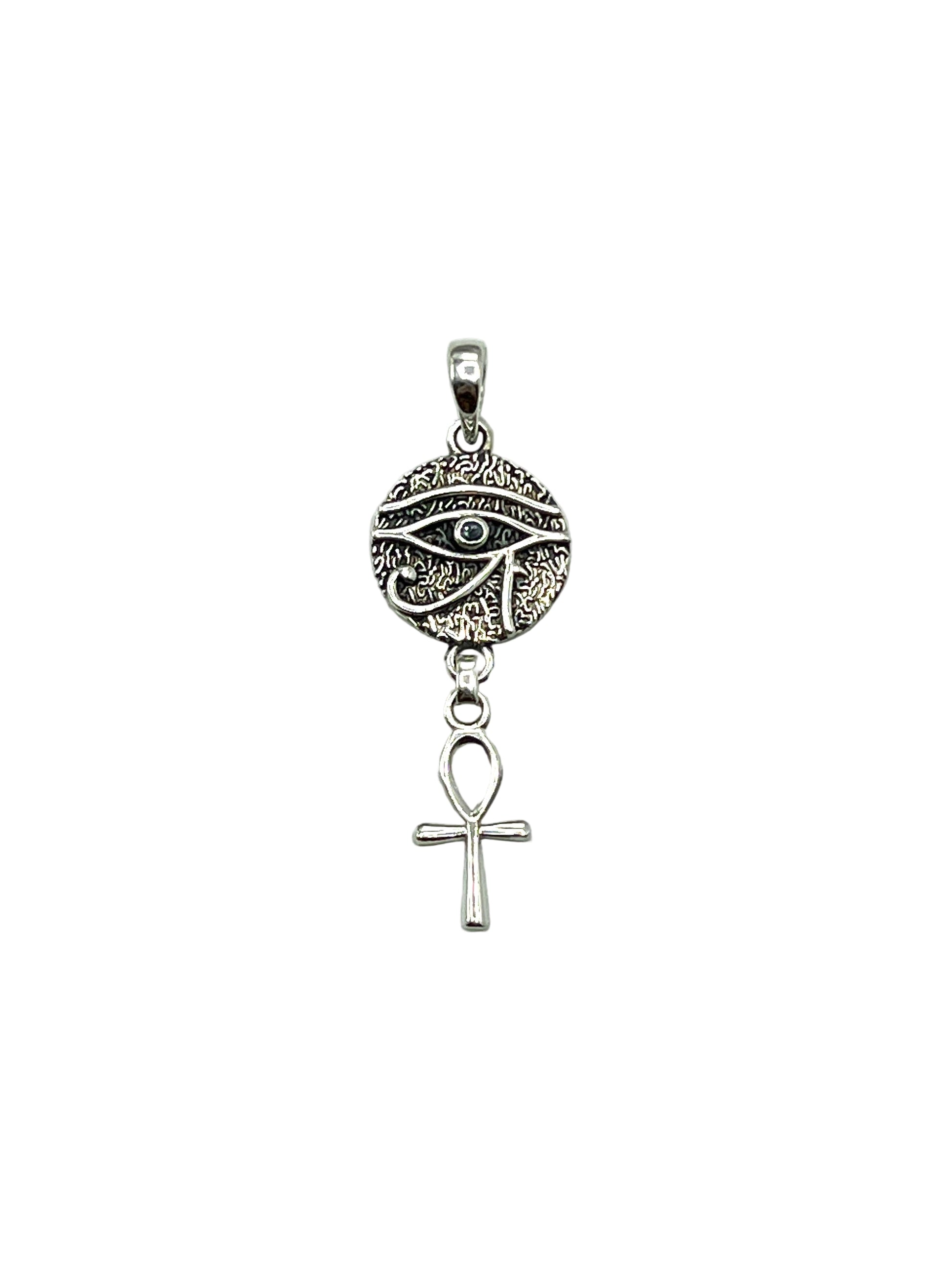 Silver pendant with eye design and ankh symbol on a light gray background