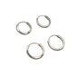 Four silver hoop earrings on a gray background