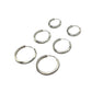 Set of silver hoop earrings on a gray background