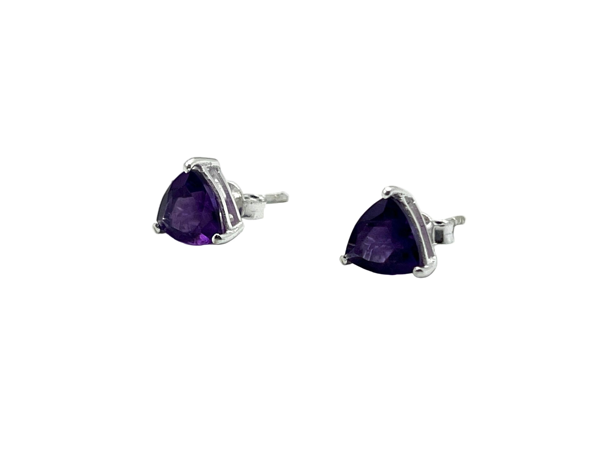 Pair of silver earrings with purple gemstones on a white background