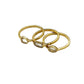 Three gold rings stacked on a white background