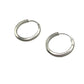 Pair of silver hoop earrings on a gray background