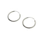 Pair of silver hoop earrings on a light gray background