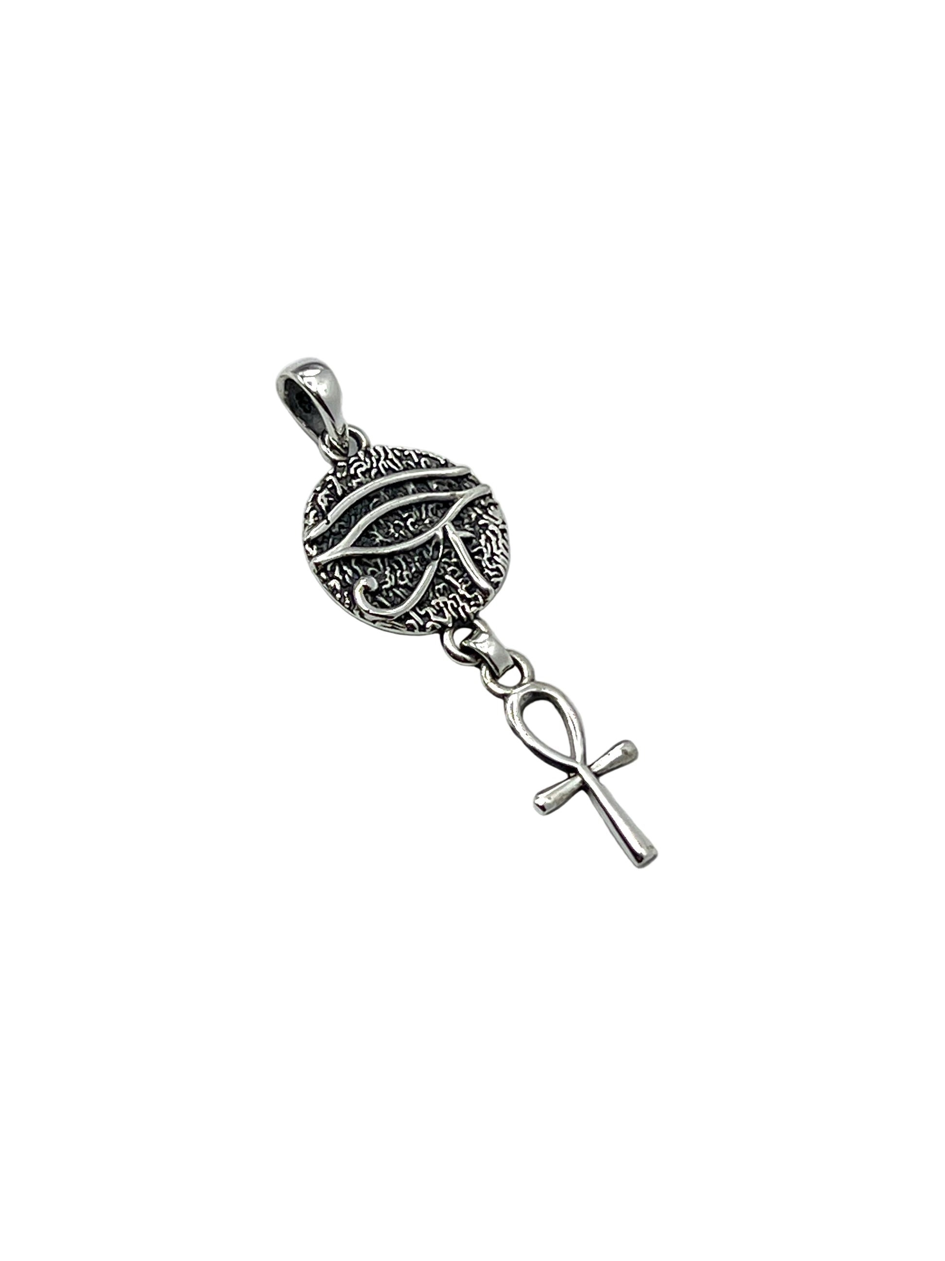 Silver pendant with horus eye and anhk on a white background