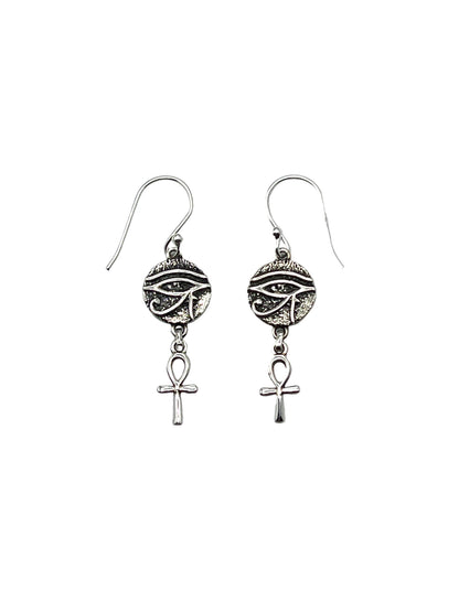Pair of silver earrings with eye design and Ankh symbol on a light gray background