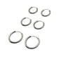 Set of silver hoop earrings on a gray background