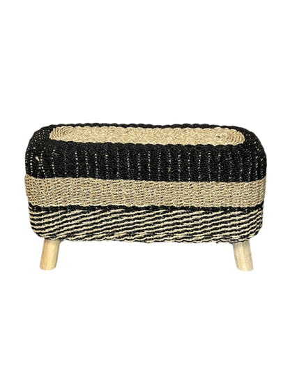 A handcrafted seagrass accent bench with black and brown stripes and wooden legs.