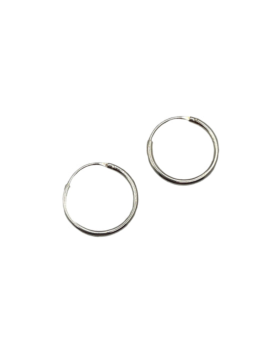 Two silver hoop earrings on a gray background