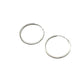 Two silver hoop earrings on a gray background