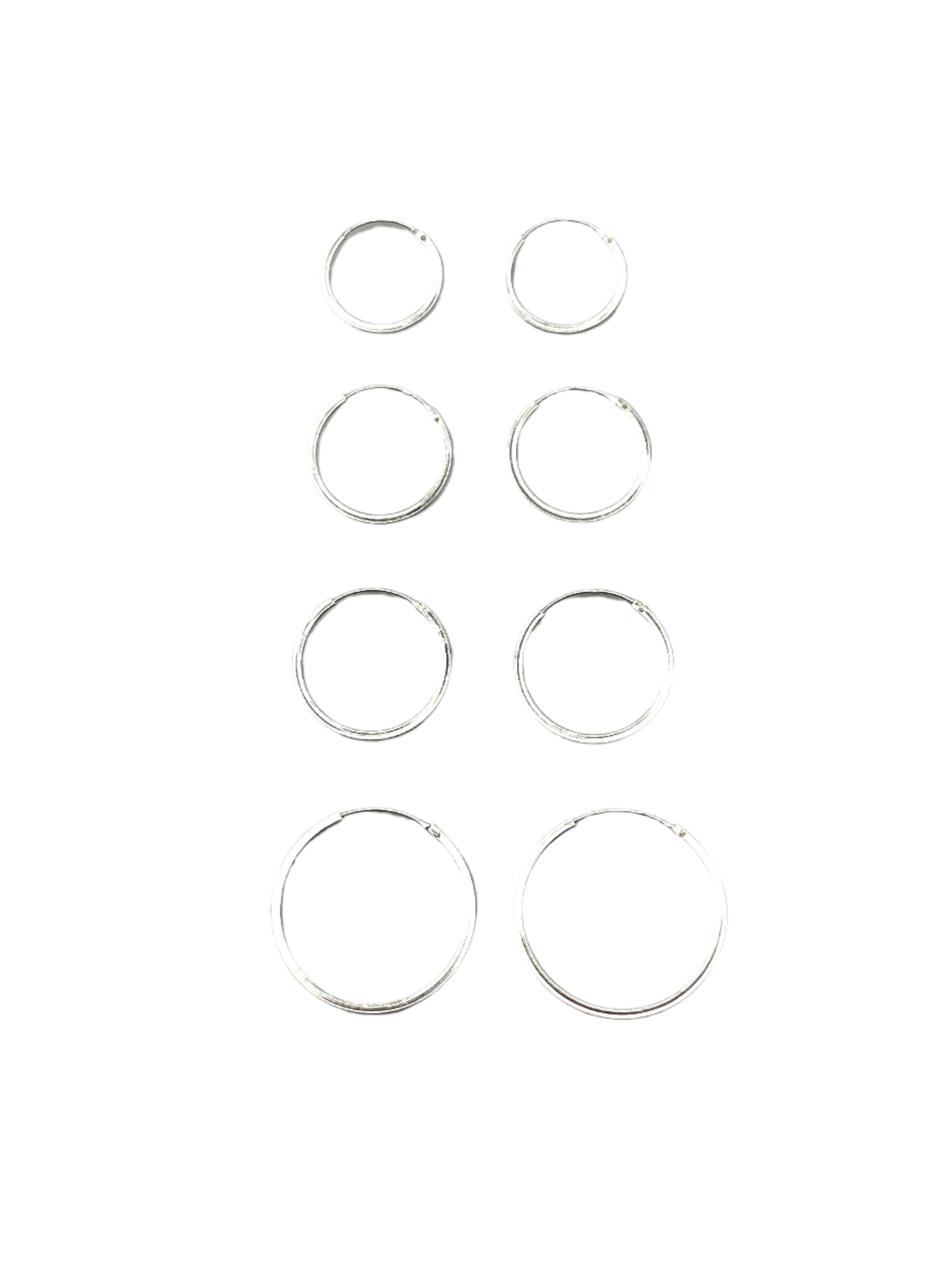 Set of silver hoop earrings on a gray background