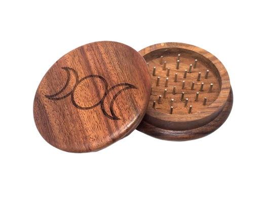 Wooden herb grinder with lid on a white background